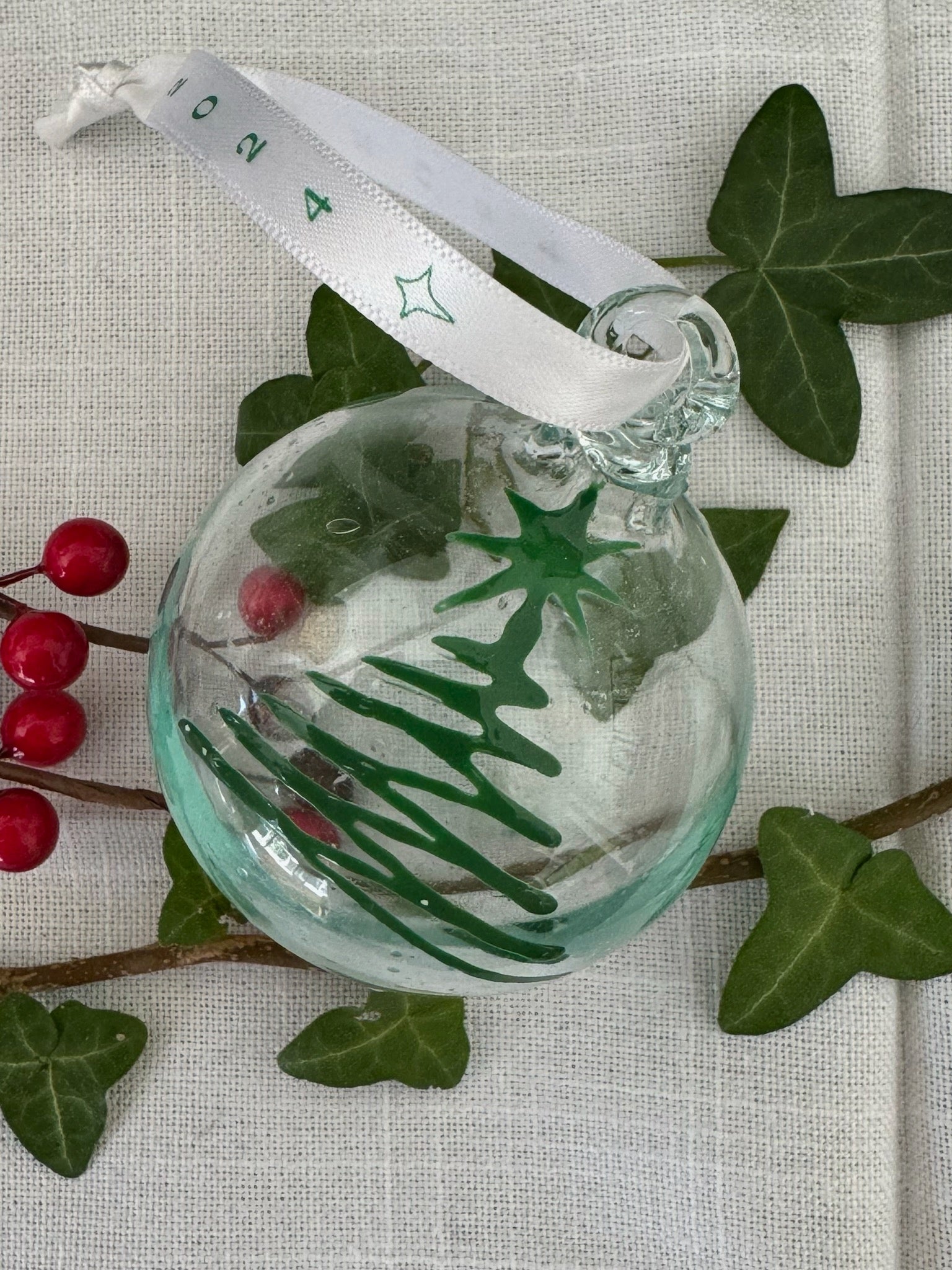 Clear glass recycled Christmas bauble painted with Green Christmas tree. Handmade in Bethlehem