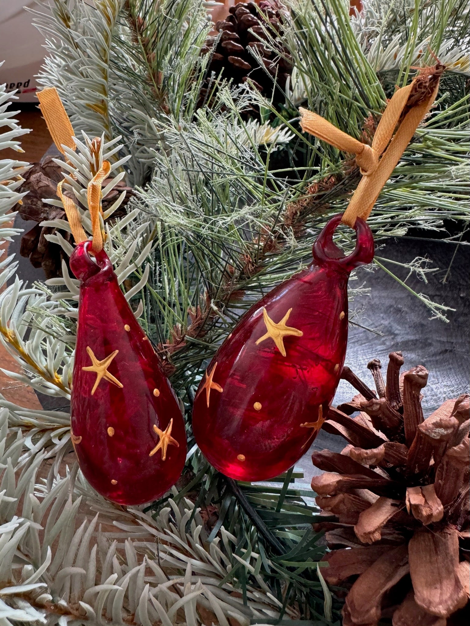 Mini glass Christmas baubles painted with gold stars and hanging on gold ribbon. handmade in Bethlehem